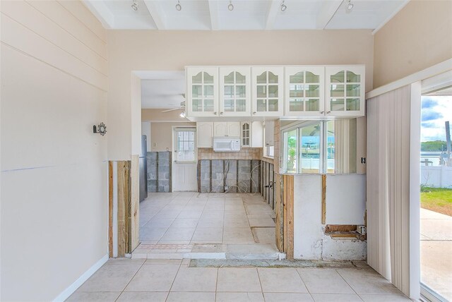 365 La Hacienda Dr, Indian Rocks Beach, FL 33785 - corridor with light tile patterned floors and plenty of natural light