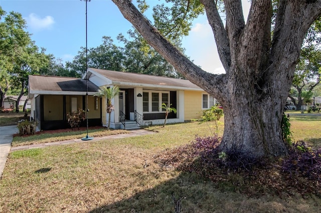 view of front of house with a front lawn, a carport, and concrete driveway