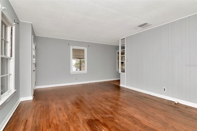 spare room with wood finished floors and baseboards