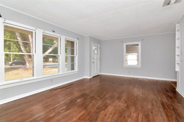 unfurnished room with wood finished floors and baseboards