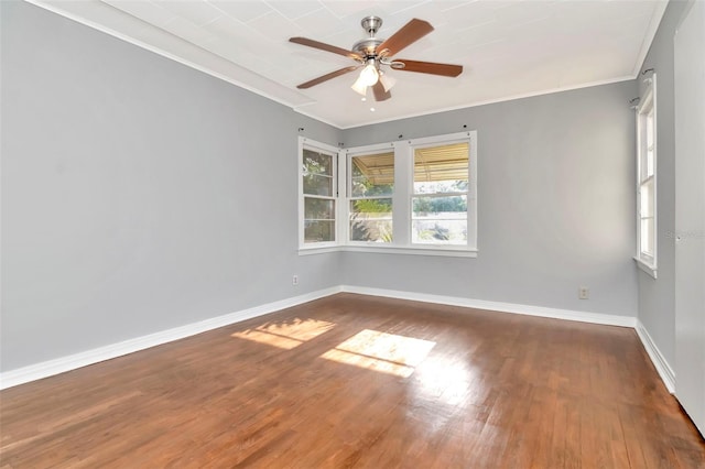 unfurnished room with crown molding, wood finished floors, baseboards, and ceiling fan