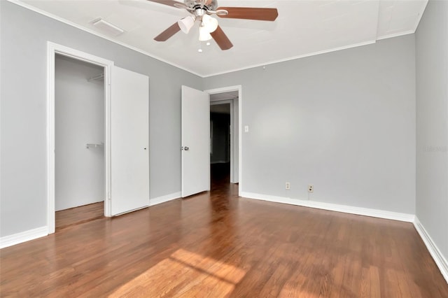 unfurnished bedroom with wood finished floors, baseboards, ornamental molding, and a ceiling fan