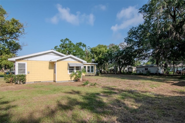rear view of house featuring a lawn