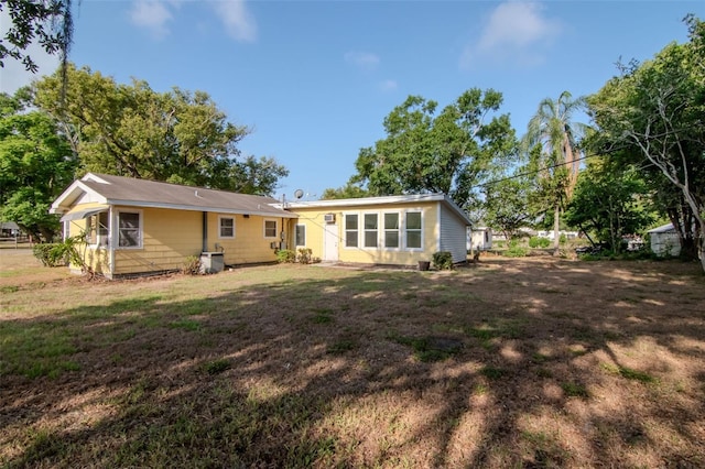 back of property with a lawn