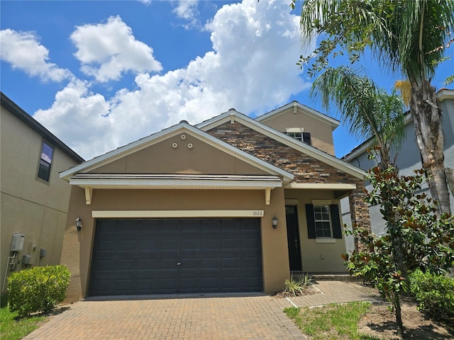 1022 Oliveto Verdi Ct, Brandon, FL 33511 - view of front of house featuring stucco siding, decorative driveway, and a garage