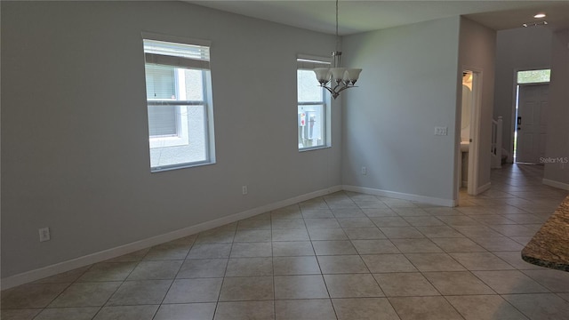 1022 Oliveto Verdi Ct, Brandon, FL 33511 - unfurnished room with plenty of natural light, light tile patterned floors, a chandelier, and baseboards