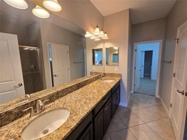 1022 Oliveto Verdi Ct, Brandon, FL 33511 - bathroom with double vanity, a stall shower, baseboards, and tile patterned flooring