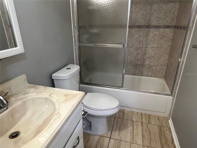 2068 San Marino Way N, Clearwater, FL 33763 - full bath featuring vanity, toilet, enclosed tub / shower combo, and tile patterned flooring