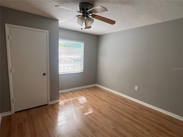 2068 San Marino Way N, Clearwater, FL 33763 - unfurnished room with ceiling fan, a textured ceiling, light wood finished floors, and baseboards
