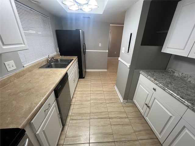 2068 San Marino Way N, Clearwater, FL 33763 - kitchen with dishwasher, light tile patterned floors, a sink, white cabinetry, and stove