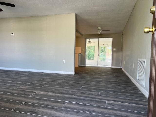 empty room featuring a ceiling fan, wood finished floors, and baseboards