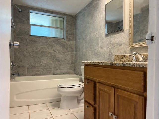 full bath featuring tile patterned floors, toilet, bathtub / shower combination, tile walls, and vanity