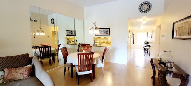 dining area with a chandelier and wood finished floors