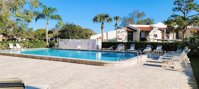 community pool with a patio area