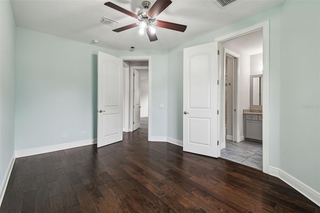 unfurnished bedroom featuring dark wood-type flooring and baseboards