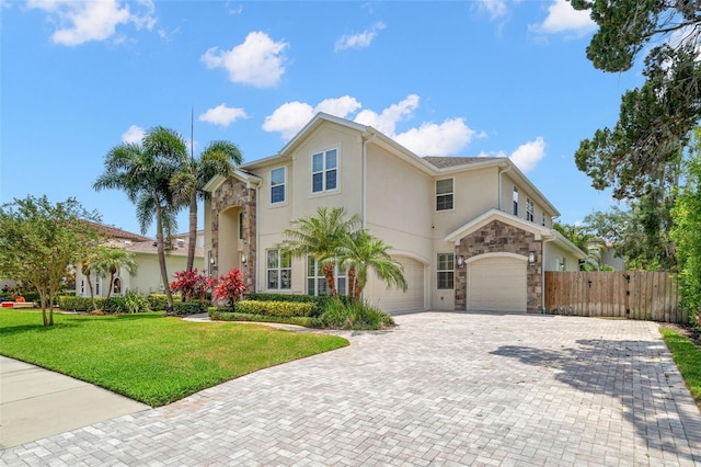 view of front of property with stone siding, a garage, stucco siding, and decorative driveway