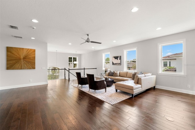 living area featuring dark wood finished floors, ceiling fan, recessed lighting, and baseboards