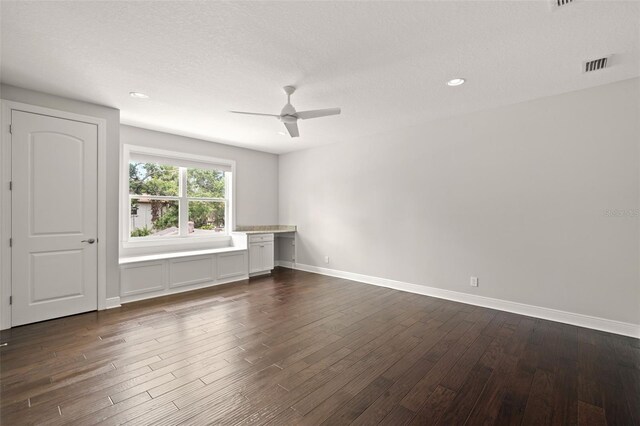 unfurnished living room with a ceiling fan, dark wood-type flooring, baseboards, recessed lighting, and a textured ceiling