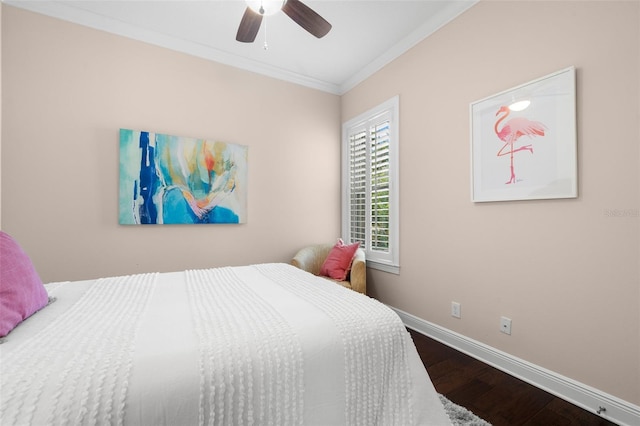 bedroom with crown molding, wood finished floors, baseboards, and a ceiling fan