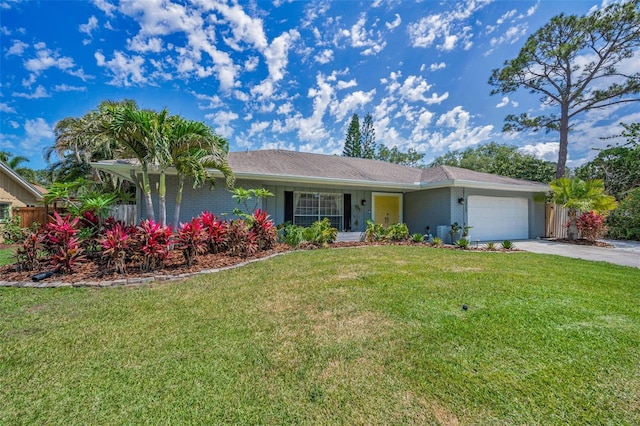 single story home with concrete driveway, an attached garage, a front yard, and brick siding