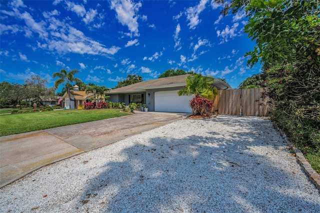 ranch-style house with an attached garage, driveway, and stucco siding