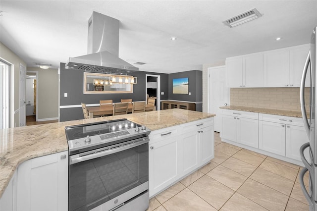 kitchen featuring appliances with stainless steel finishes, tasteful backsplash, white cabinetry, island range hood, and recessed lighting