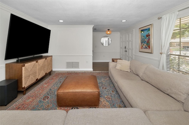 living area with ornamental molding and recessed lighting