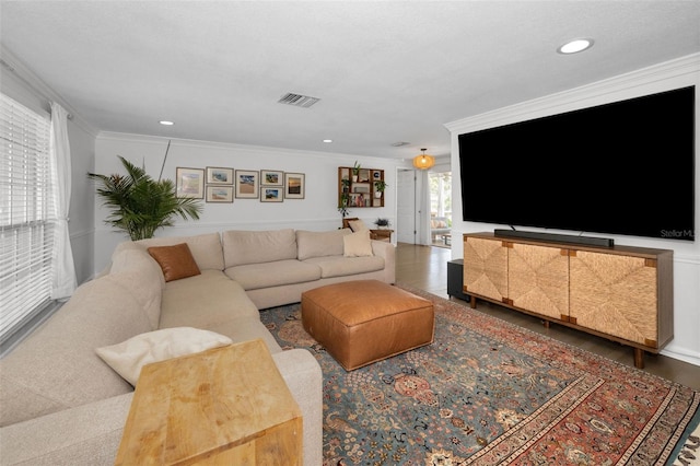 living room featuring ornamental molding and recessed lighting