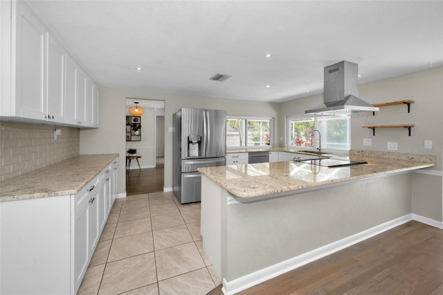 kitchen featuring stainless steel refrigerator with ice dispenser, island range hood, a peninsula, open shelves, and electric stovetop