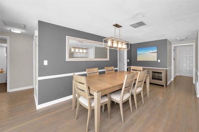 dining area with wood finished floors and baseboards
