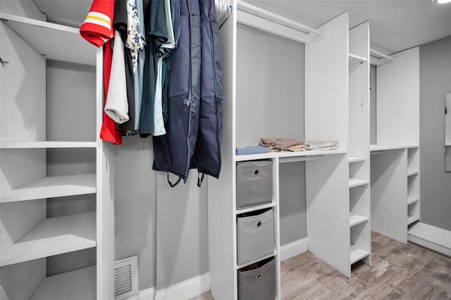 walk in closet featuring wood finished floors