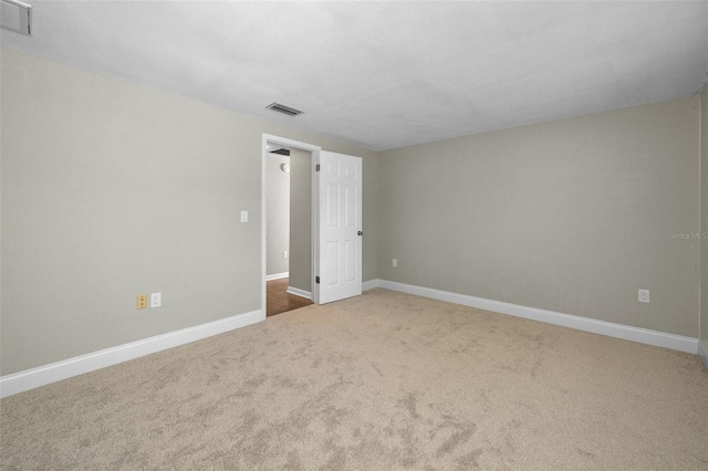 unfurnished room with carpet flooring and baseboards