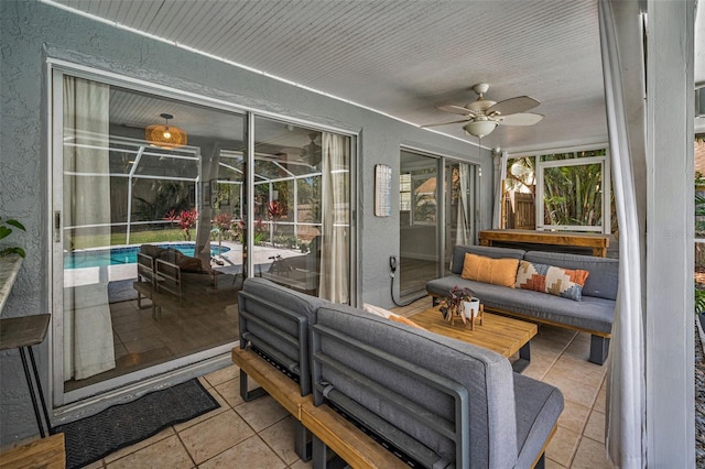 sunroom / solarium featuring a ceiling fan and an outdoor living space