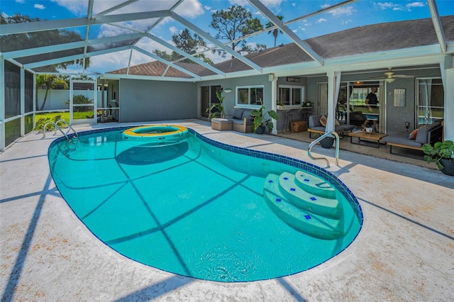 view of swimming pool with a patio area, a lanai, and ceiling fan