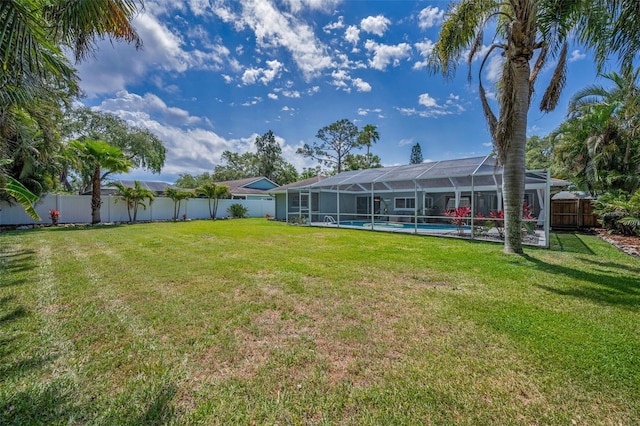 view of yard with glass enclosure