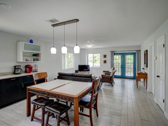 106 E Cedar St, Tarpon Springs, FL 34689 - dining space with light wood-style floors and french doors