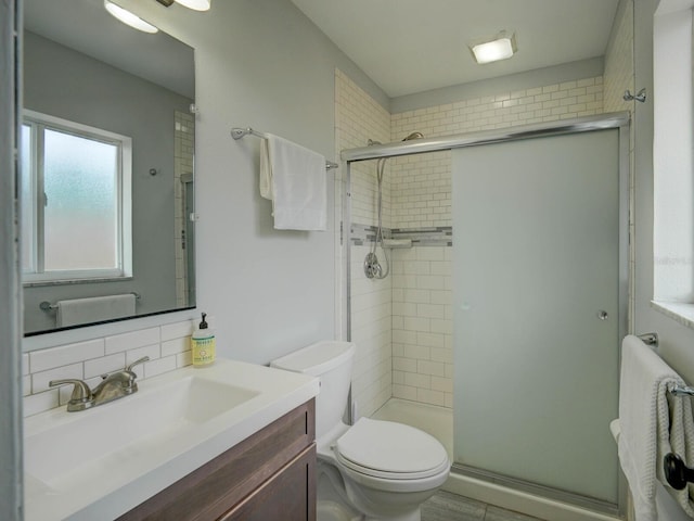 106 E Cedar St, Tarpon Springs, FL 34689 - full bath with a stall shower, toilet, vanity, and tasteful backsplash