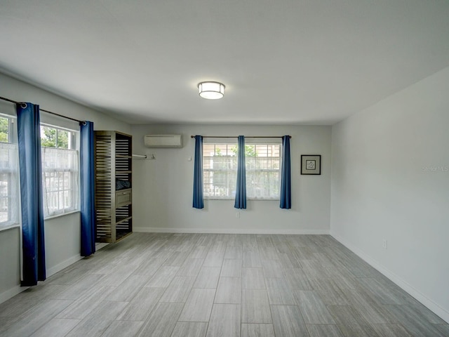 106 E Cedar St, Tarpon Springs, FL 34689 - empty room with a wall mounted AC, wood finished floors, and baseboards