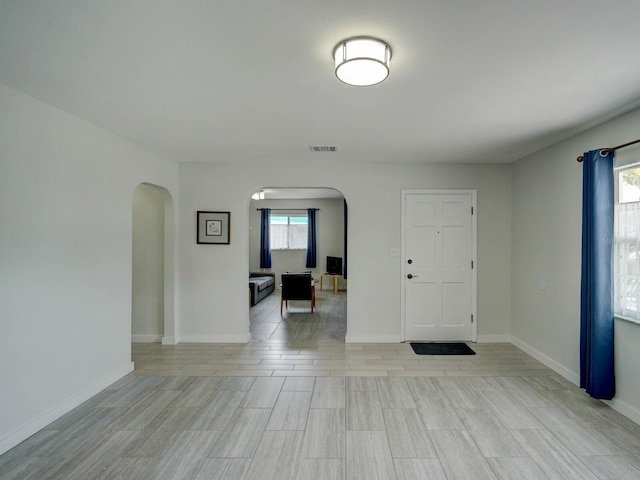 106 E Cedar St, Tarpon Springs, FL 34689 - entrance foyer featuring arched walkways, baseboards, and light wood-style flooring