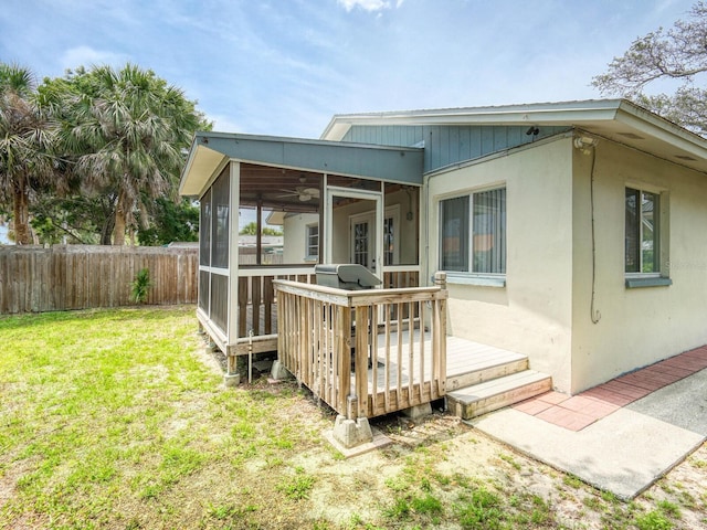 106 E Cedar St, Tarpon Springs, FL 34689 - rear view of property with a sunroom, a deck, and ceiling fan