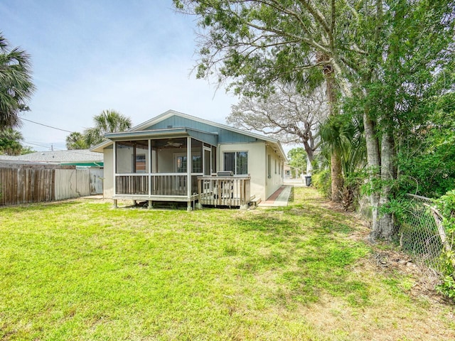 106 E Cedar St, Tarpon Springs, FL 34689 - back of property with a sunroom and a wooden deck