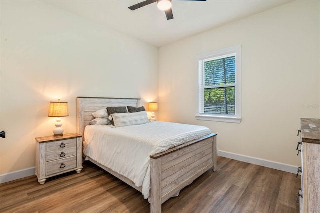 bedroom featuring wood finished floors, baseboards, and ceiling fan