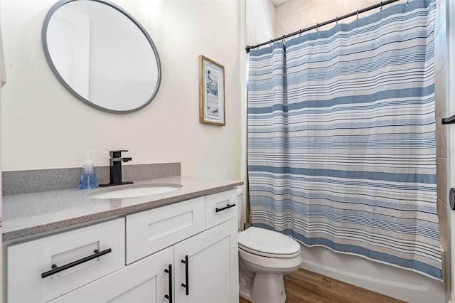 full bathroom with wood finished floors, toilet, vanity, and shower / bath combo with shower curtain