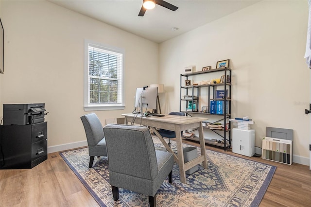 office featuring a ceiling fan, wood finished floors, and baseboards