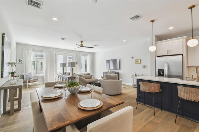 dining room with ceiling fan, light wood-style flooring, recessed lighting, and baseboards