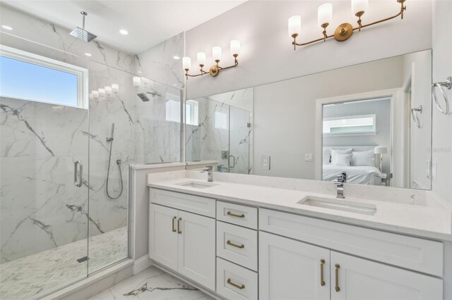 ensuite bathroom featuring marble look tile flooring, a marble finish shower, double vanity, and recessed lighting