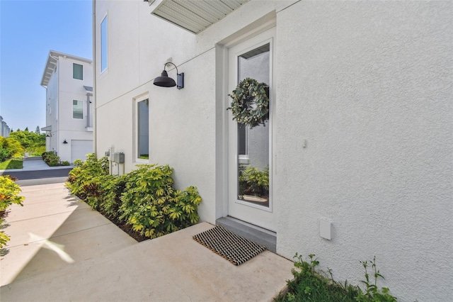 property entrance with stucco siding