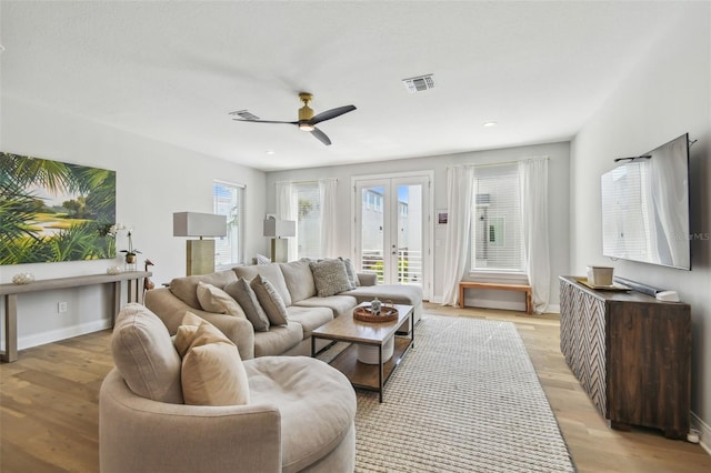 living room with french doors, ceiling fan, light wood-style floors, baseboards, and recessed lighting