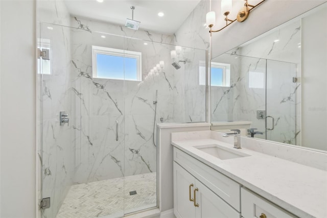 bathroom with a marble finish shower, vanity, and recessed lighting