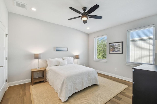 bedroom with baseboards, wood finished floors, recessed lighting, and a ceiling fan
